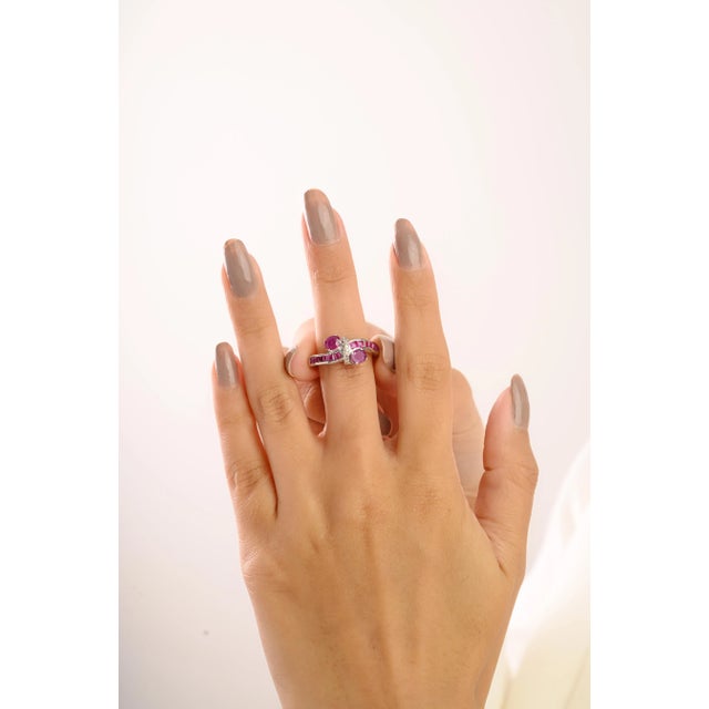 This 925 Sterling Silver Ruby and Diamond Ring features a stunning mix of oval and square rubies totaling 3.25 carats,...