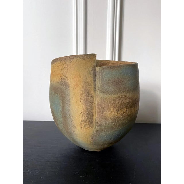 A stoneware vessel with glazed and banded stripes design by British studio ceramist John Ward (1938-) circa 1980s. The...