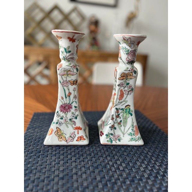 What a beautiful pair! These hand-painted, porcelain, candlestick holder set is adorned in a blooming butterfly garden...