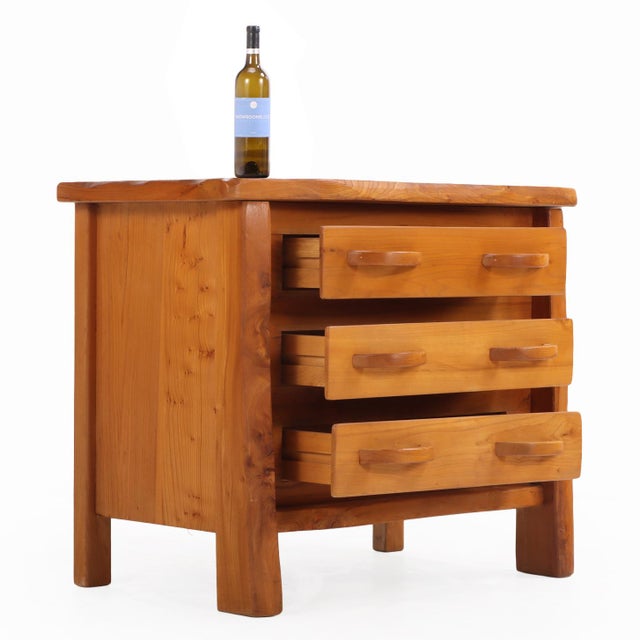 Gorgeous and versatile, this elm dresser is indicative of all the hallmarks of 70's French brutalist design. The honey...