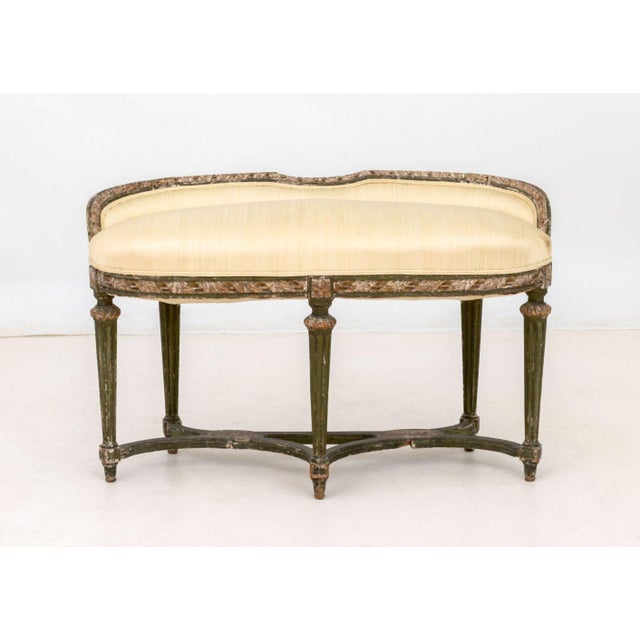 Louis XVI Style Upholstered Distressed Painted Window Seat, with beige upholstery on five rosette fluted tapered legs...