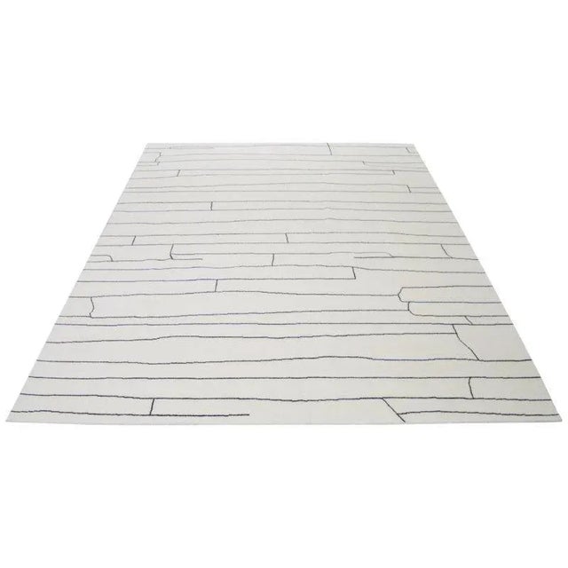 Moroccan hand knotted wool rug with abstract design.