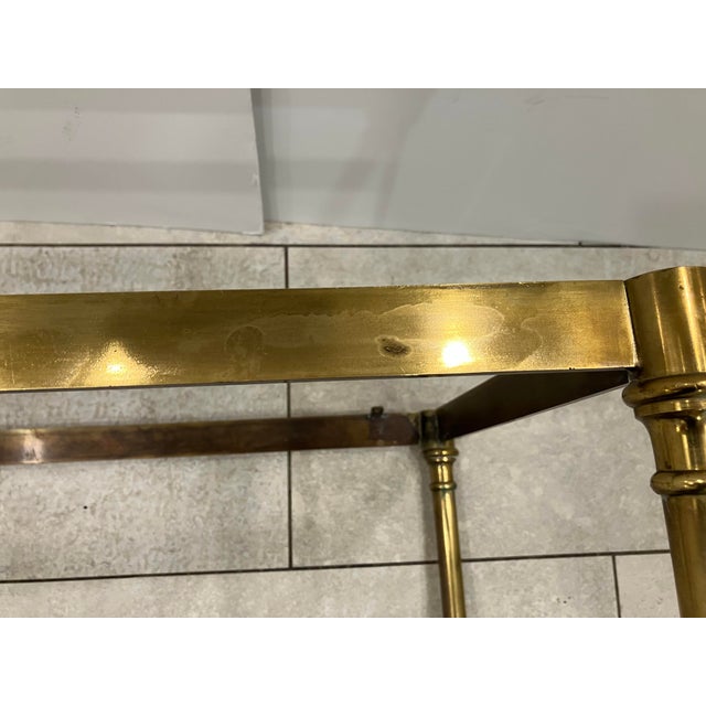 This very well crafted brass bench was made in Italy in the 80’s The seat cushion is upholstered in a quality vinyl The...