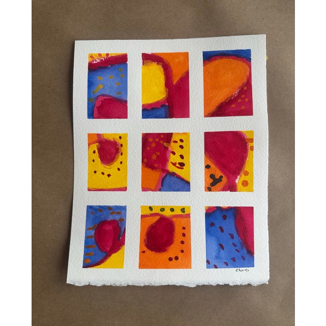 A joyful original abstract watercolor composed of nine expressive panels in saturated jewel tones of cobalt blue, crimson,...