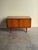 Danish teak compact credenza, crafted in the 1960s. Defined by clean sculptural lines and rich teak grain, this elegant...