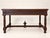 A flat desk in solid dark-stained oak, in the louis xiii style, likely made in the 19th century. the front features two...