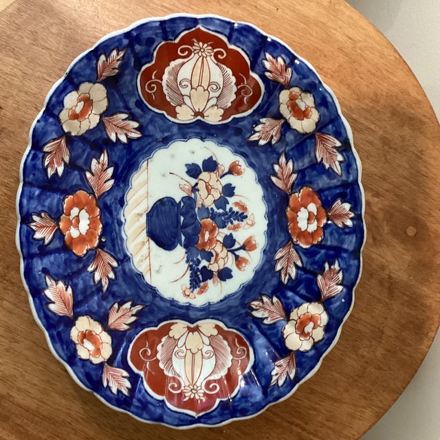 This Antique Japanese Imari Porcelain hand painted Oval Scalloped Platter from circa 1900s is a beautiful and unique piece...