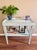 Wooden, two-tier side table refinished in Sherwin Williams’ Rainwashed. This charming piece has enough space to hold books...