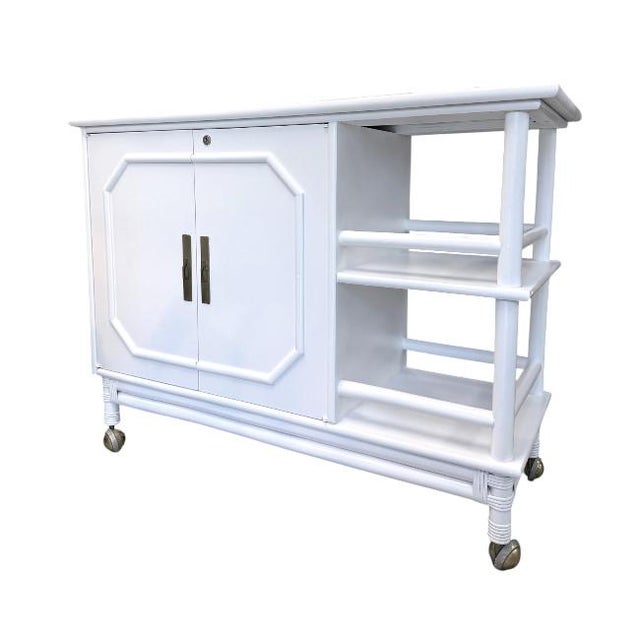 Freshly refinished in a crisp white lacquer, this stylish vintage faux bamboo bar cart blends Palm Beach glamour with...
