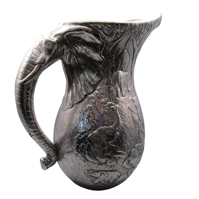 This vintage Arthur Court 1980 cast aluminum pitcher is a striking example of functional art. Adorned with jungle safari...