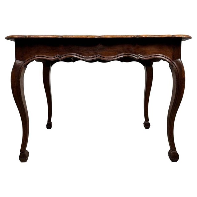 An elegant early 20th-century French writing table, finely crafted from oak and distinguished by its unusually generous...