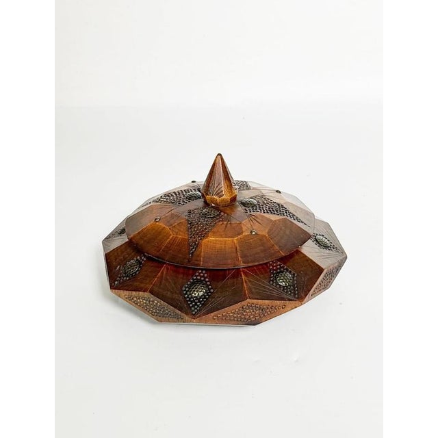 Decorative carved wooden box, France, 1970s. An elegant wooden box crafted in a traditional style with a striking faceted...