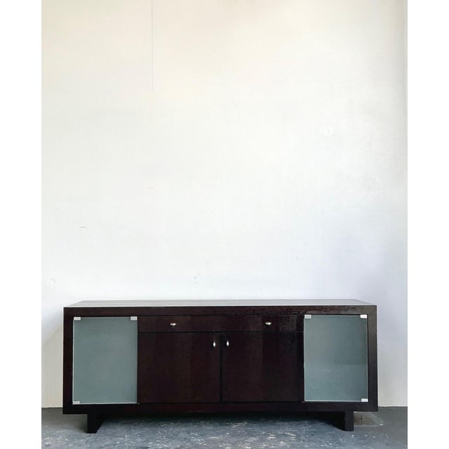 This refined vintage sideboard exemplifies the clean lines and understated sophistication of mid-century modern design....