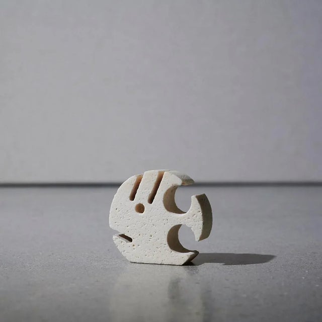 Fish sculpture made of travertine marble.