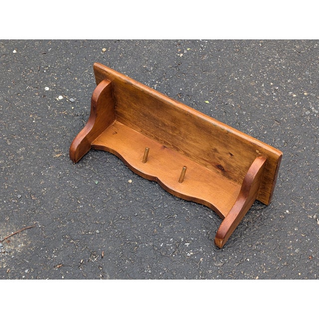 Add a touch of vintage-inspired charm to your entryway with this handcrafted wooden wall shelf, featuring an elegant...