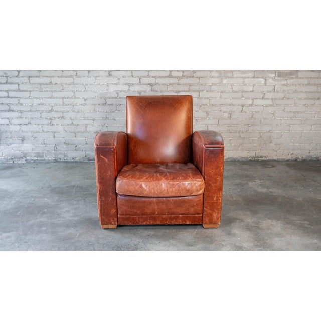 Vintage Art Deco distressed cognac leather club chair, circa 1970s. Lovely distressed cognac amber leather, showing aged...