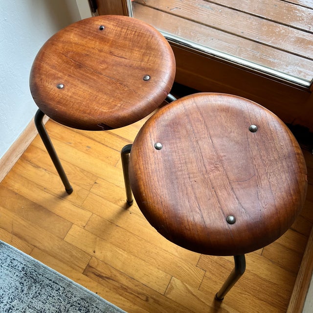 Rare pair of mid century Scandinavian three-leg “dot” stools marked Stalmøbler (steel furniture). These feature round teak...