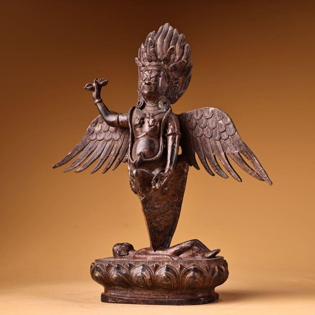 This is a striking antique Tibetan fire-gilded bronze statue of Garuda, a powerful winged deity in Buddhist and Hindu...