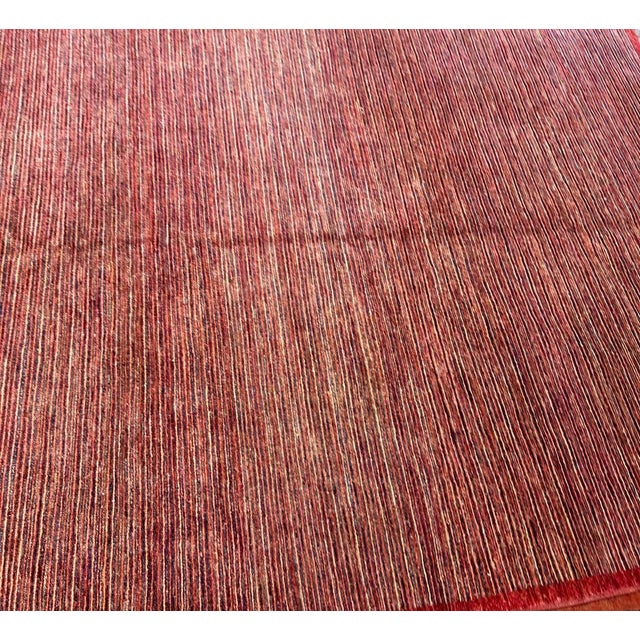 A distinctive vintage Turkish rug defined by its finely striated surface and subtle, rhythmic movement of color. At first...