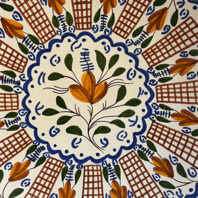 Large hand-painted Spanish ceramic plate made in Manises. Decorated with alternating tressils and florals around a large...
