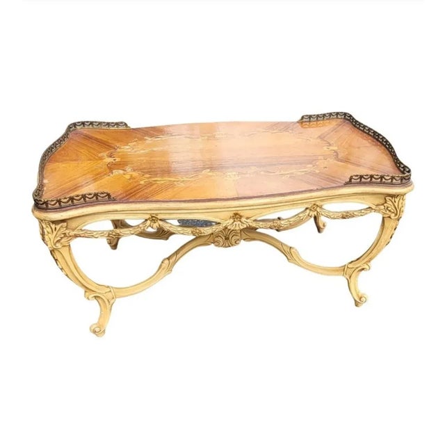 Gorgeous Antique French Louis XV coffee table, from the 1910s. This table is made of walnut wood and kingwood, featuring...