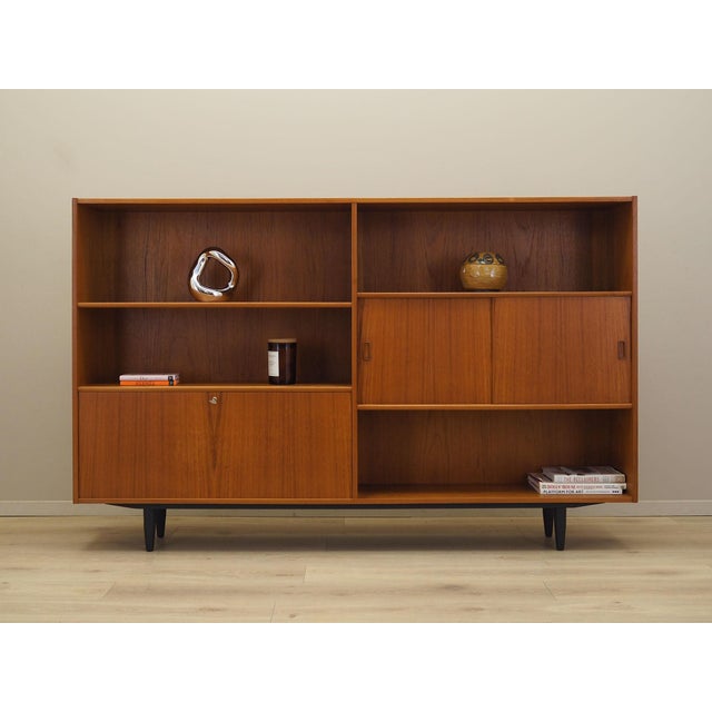 The bookcase made in the 1960s by the renowned Danish manufacturer Westergaard Møbelfabrik. The structure is covered with...