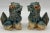 A striking matched pair of ceramic Foo Dogs (Shishi / Guardian Lions), glazed in celadon-blue and tan with expressive...