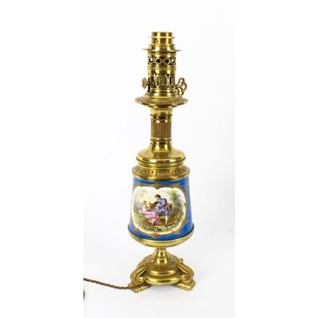 This is an exquisite large pair of French Sèvres Porcelain and ormolu mounted oil burning table lamps that have been...