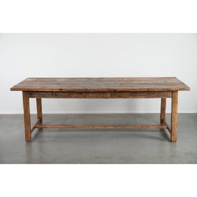 We are offering this beautiful and sturdy large antique farmhouse dining table made of pine wood with lots of character...