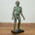 A vintage Greco-Roman style bronze nude statue from the 20th century with verde patina and wooden pedestal base. Created...