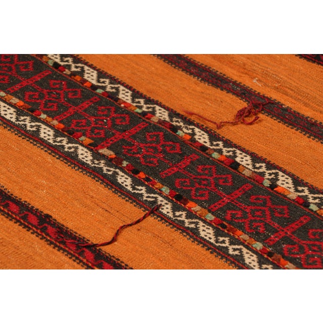 Handwoven in wool, circa 1950-1960, this 2x5 vintage Afghan tribal kilim, is a collectible tribal piece that may have been...