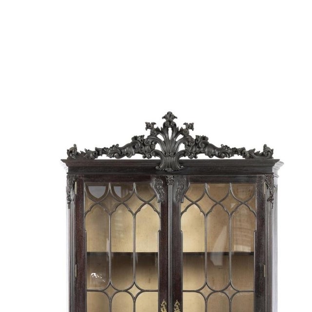 Furniture - Pair of display cabinets. Portuguese, early 20th century, in carved chestnut wood with two glazed doors,...