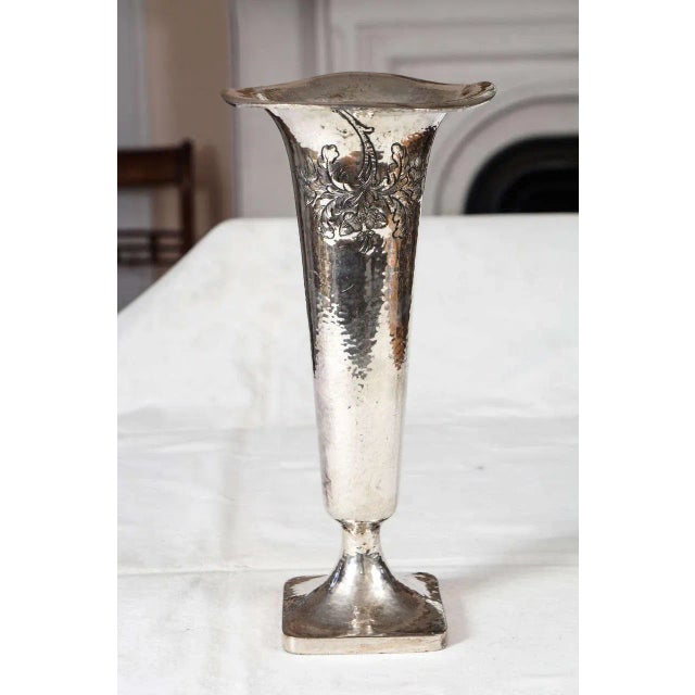 Silver plated Victorian trumpet form vase with raised, hammered detailing of leaves on the front. 4" pedestal base.
