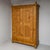 Softwood wardrobe with two doors and gracefully rounded corners, topped with decorative finials. Each door features double...
