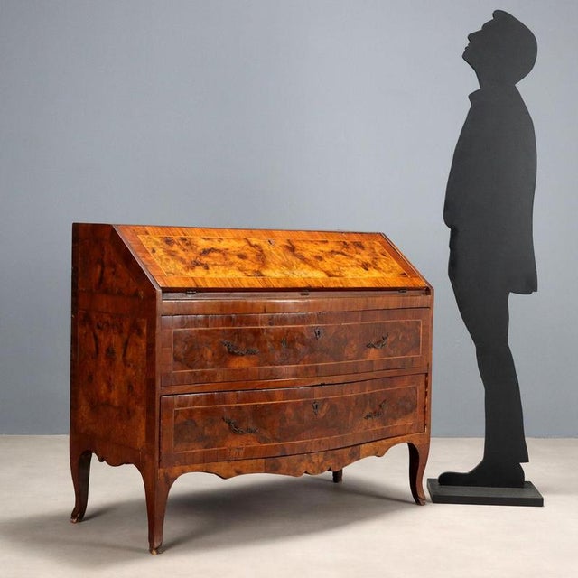 A mid-18th century Baroque drop-leaf chest of drawers. Constructed of fir and poplar and clad in walnut with large burl...
