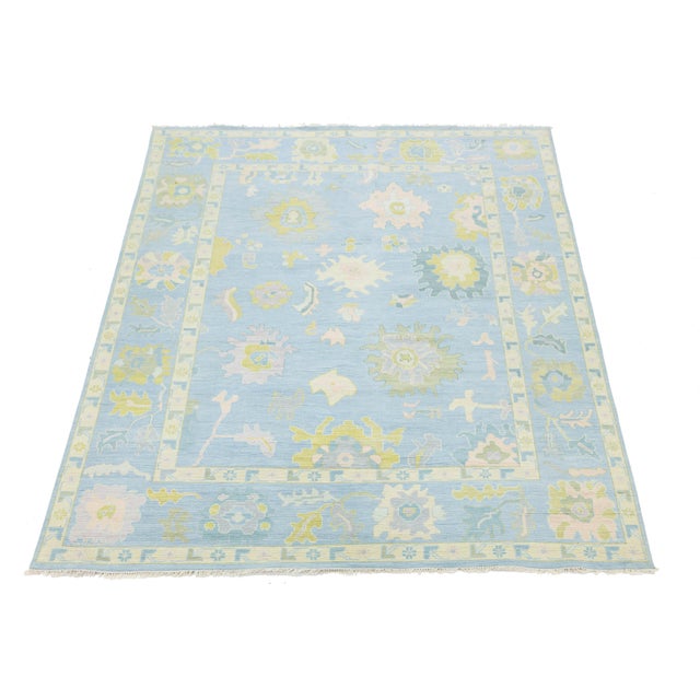 This modern Oushak style rug revitalizes traditional Turkish design with a light color palette. Hand-knotted from wool, it...