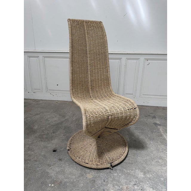 Sculptural silhouette for this slender rattan and rope armchair dating from the 1980s and originating from Italy....