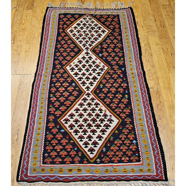 A beautiful vintage Persian Senneh kilim from the Kurdish region of Western Persia, this finely hand woven flat-weave rug...