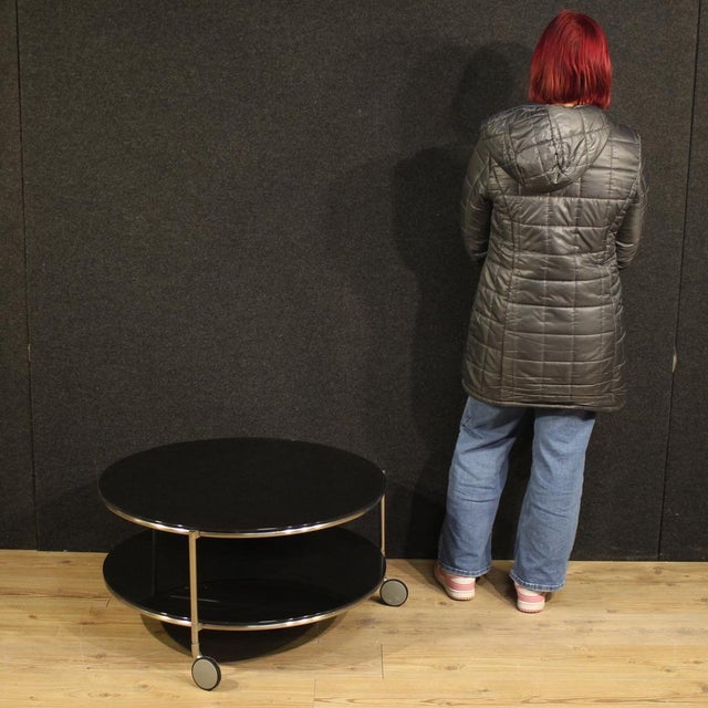 Coffee table on casters, Italy, 1980s. A round, chrome-plated metal table with two frosted glass tops, it has a beautiful,...