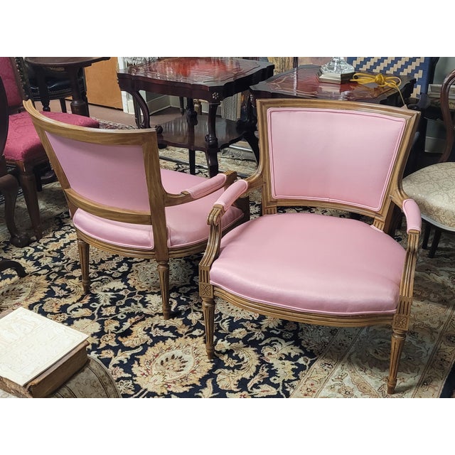 A beautiful pair of hot pink 1950s Napoleonic French armchairs. Each chair features satin like cotton hot pink upholstery...