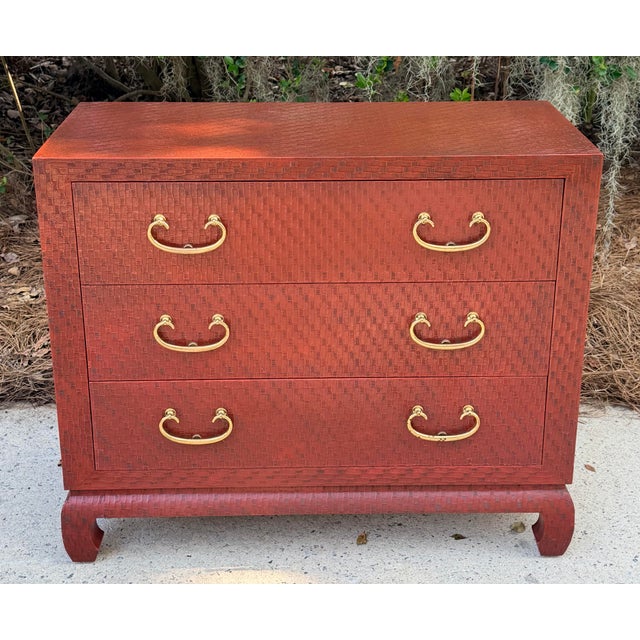 Stunning 1980s Baker ming style grasscloth dresser in a Chinese red that is just sublime. The quality of this chest cannot...