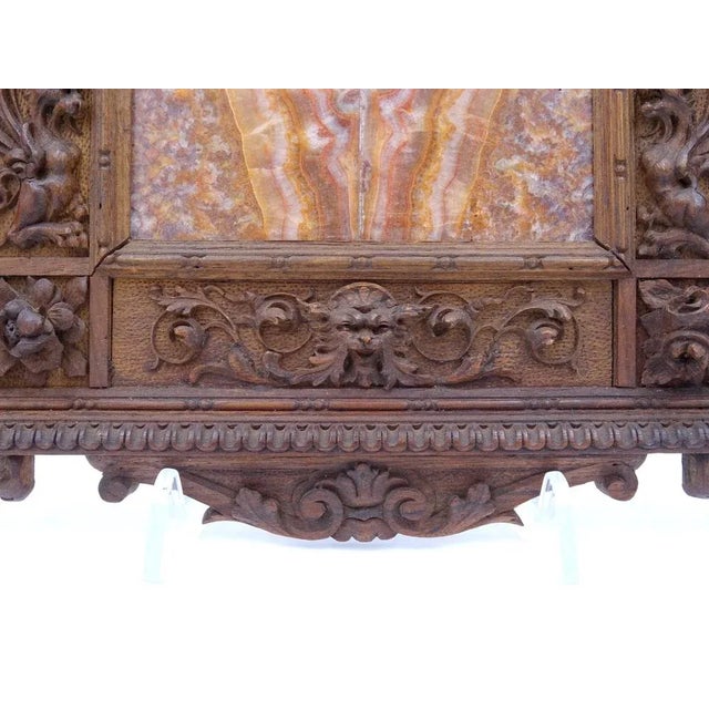 Walnut wood frame finely carved with naturalistic and fantastic motifs of seventeenth-century taste. The frame frames a...