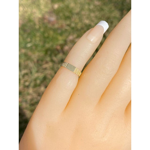 The Wooh: Childs Yellow Gold Signet Ring. This child's ring features a rectangular center set East to West with stepped...
