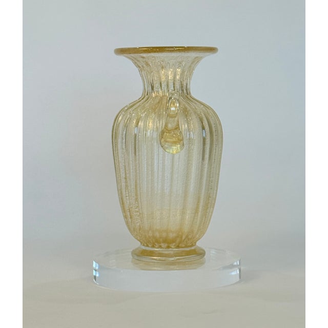 This Murano vase was made by master glassmaker Alberto Dona. Handblown in Murano, Italy The vase is infused with delicate...
