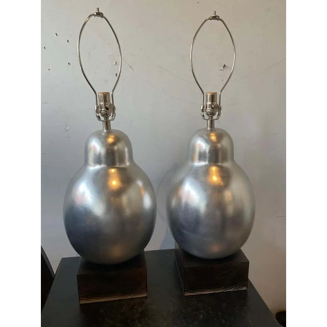 Pair of Hwang Bishop resin lamps in silver leaf finish.Height is to top of socket. Shades not included. Lamps have...