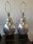 Pair of Hwang Bishop resin lamps in silver leaf finish.Height is to top of socket. Shades not included. Lamps have...