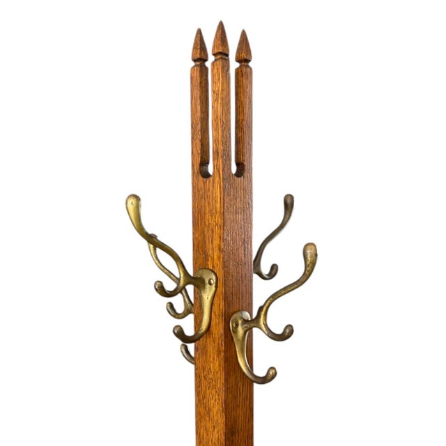 A Gothic twist lends distinctive style to this circa 1910 American Arts and Crafts coat rack. Crafted of oak, the square...