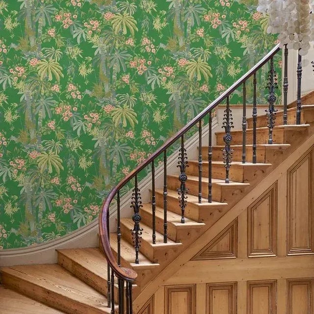 This tropical wallpaper has a vibrant mood with floral blossoms intertwined with bamboo presented on a vivid green...