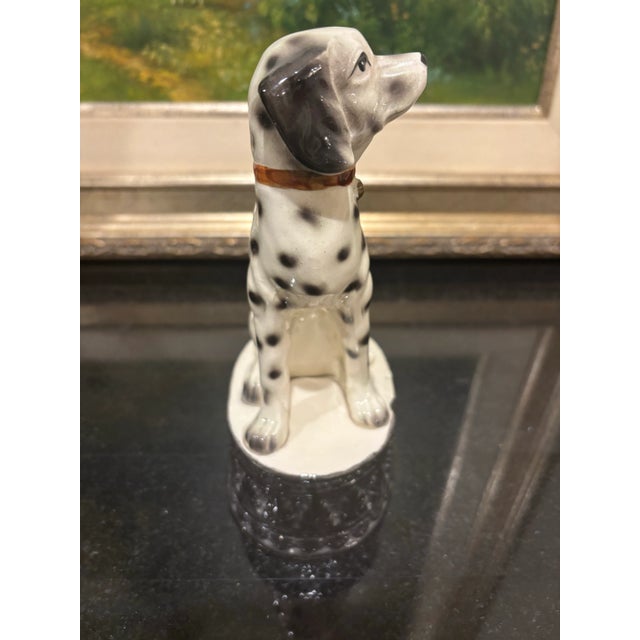 Offered is a vintage black and white spotted dog figurine. This piece is marked on the underside “Japan”.