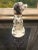 Offered is a vintage black and white spotted dog figurine. This piece is marked on the underside “Japan”.